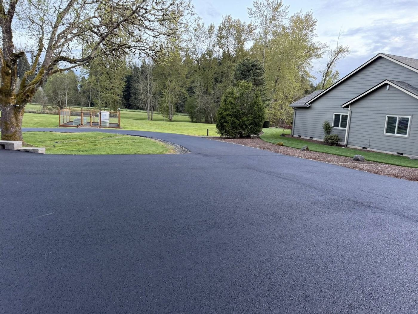 After: Fresh jet-black sealed driveway