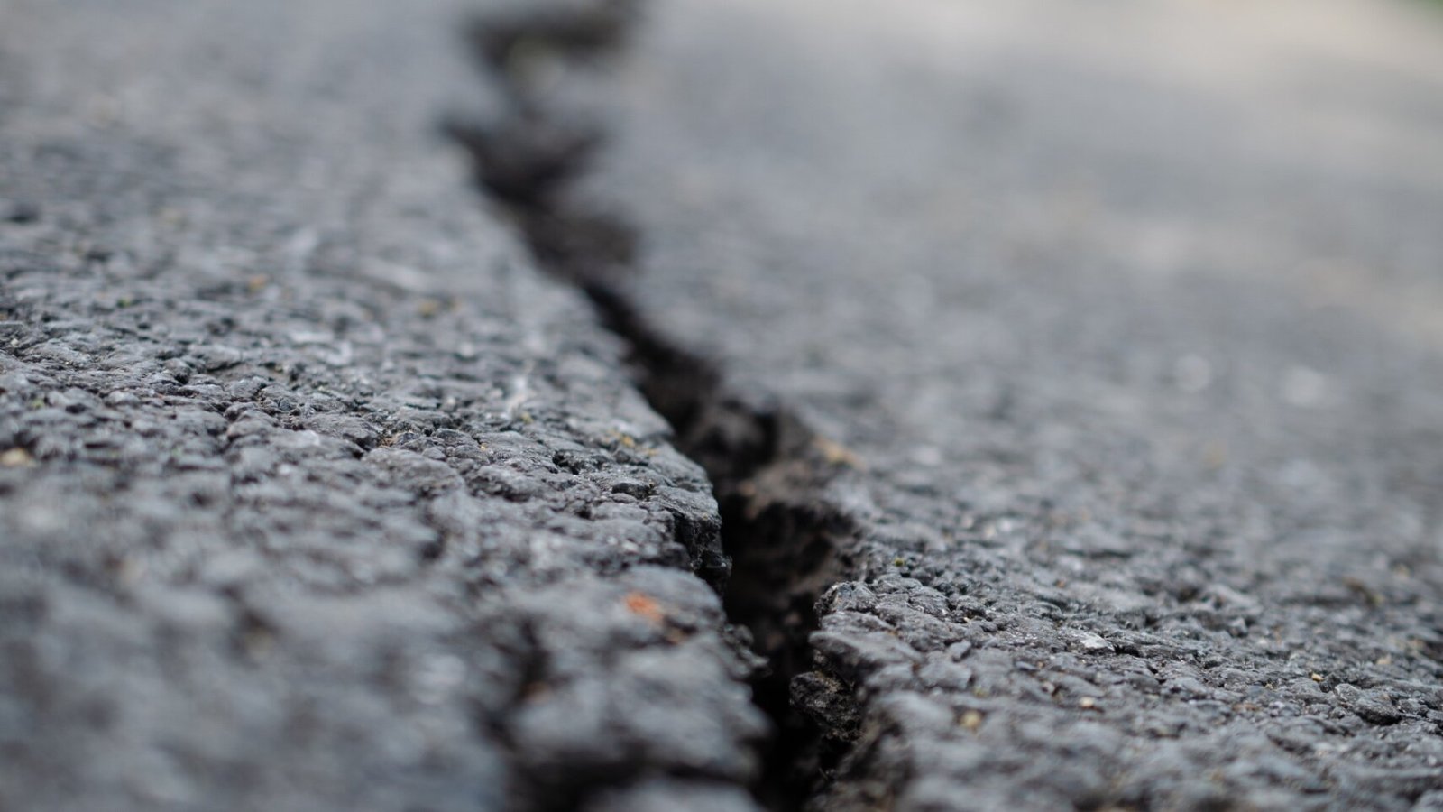 Close-up of asphalt crack repair  crack filling prevents water infiltration and costly deterioration